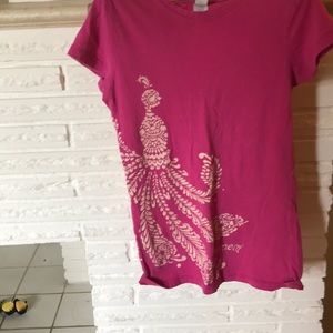 This is a pink shirt with tan design.